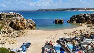 a group of boats parked on a sandy beach at T2 Baleal in Peniche