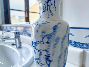 a blue and white vase sitting on a bathroom counter at Almaterra Apartamentos Turísticos in Huéscar +61 photos
