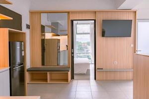 a kitchen with a sliding glass door with a television at Orbit House in Bandung