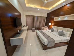 a bedroom with a large bed and a television at Love Kush Hotel in Kishangarh