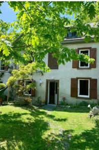 a white house with a yard with a tree at Le Refuge du Cap in Cescau +17 photos