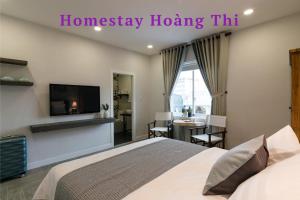 a bedroom with a bed and a flat screen tv at Homestay Hoàng Thi in Phan Thiet