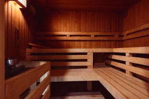 an empty wooden sauna with a stove in it at Focus Hotel Poznań in Poznań