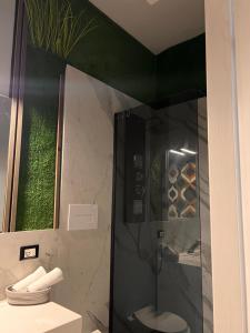 a shower with a glass door in a bathroom at LE TEMPLE DU LUXE in Agrigento