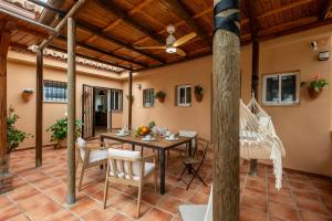 a patio with a table and chairs and a wooden ceiling at Comeback Villa Itaca in Motril