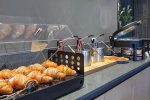 a bakery with croissants and other pastries at CUBIK inn Design Rooms in Gravina di Catania