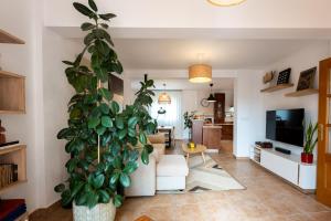 a living room with a large potted plant in it at Comeback Villa Itaca in Motril