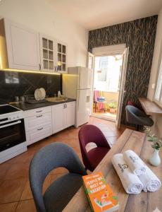 a kitchen with a table and a kitchen with a refrigerator at Amazon Hostel Center Podgorica in Podgorica