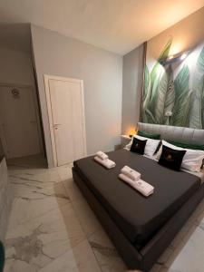 a bedroom with a large bed with two towels on it at LE TEMPLE DU LUXE in Agrigento