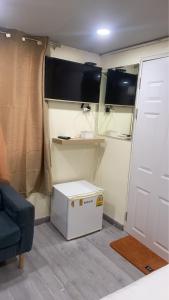 a small room with a white refrigerator and a door at Uncle Yo House in Phuket +41 photos