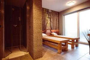 a room with two benches and a window at Focus Hotel Poznań in Poznań