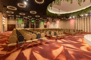 a row of chairs in a large room with lights at Hotel International Iasi in Iaşi +51 photos