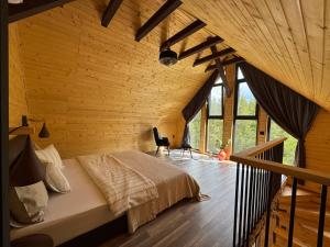 a bedroom with a bed in a room with wooden walls at Apusenity Resort I Piscină Interioară & Cabane în Natură in Cluj-Napoca