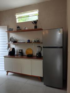 a kitchen with a stainless steel refrigerator and a window at Casa Sol in Cabo de Santo Agostinho +38 photos