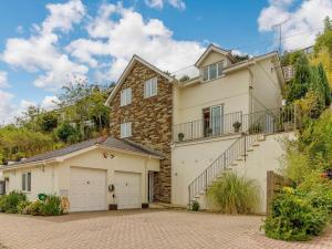 a house with a garage and a brick driveway at 4 Bed in Torpoint oc-89135 in Sheviock