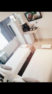 a person laying on a bed in a room at The 55 in Enfield