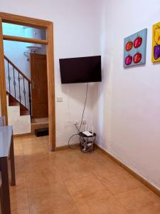 a living room with a flat screen tv on the wall at Casa Chana y Domingo- Refugio con historia y vistas en Agulo in Agulo