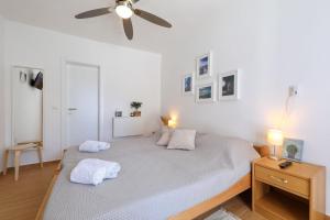 a bedroom with a bed and a ceiling fan at Hibis, No 3 in Starigrad