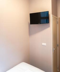 a room with a flat screen tv on the wall at CS Hotel in Amsterdam +24 photos