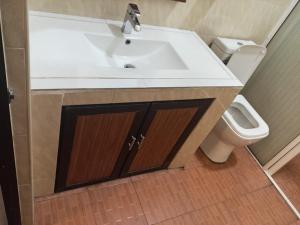 a bathroom with a sink and a toilet at THARUMINI villa in Kandy