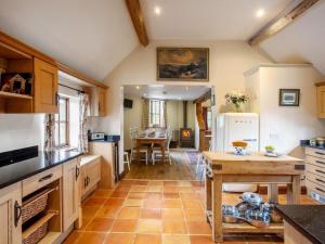 a large kitchen with a table and a dining room at 4 Bed in Gloucester oc-41216 in Tirley