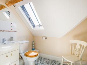 a bathroom with a toilet and a sink and a skylight at 4 Bed in Gloucester oc-41216 in Tirley +19 photos