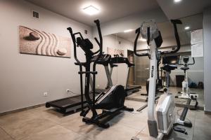 a gym with several tread machines in a room at Focus Hotel Poznań in Poznań