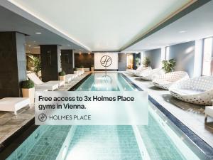 a swimming pool in a hotel with a sign free access to homes at Numa Vienna Terra in Vienna