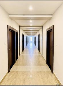 an empty hallway with doors and a long corridor at Royal Night Hotel & Resort in Gaya