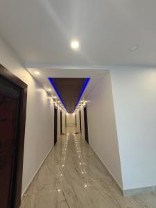 a hallway with a blue ceiling and a long corridor at Royal Night Hotel & Resort in Gaya