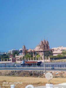 a train on a road in front of a city at Hotel Bandhan in Himatnagar