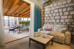 a living room with a couch and a table at Villa Diamond in Mlini