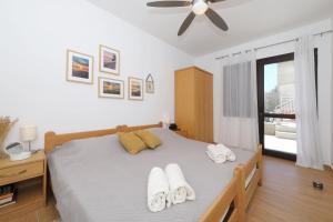 a bedroom with a bed with towels on it at Hibis, No 2 in Starigrad