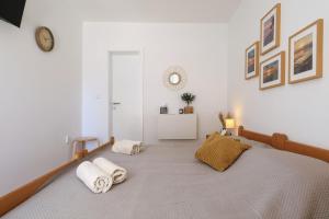 a bedroom with a large bed with towels on it at Hibis, No 2 in Starigrad +15 photos