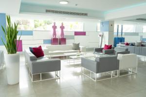 a waiting room with couches and tables and a wall at BLUESEA Marieta & Spa in Playa del Ingles