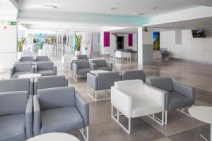 a waiting room with gray and white chairs and tables at BLUESEA Marieta & Spa in Playa del Ingles