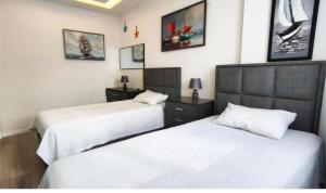 two beds in a bedroom with white sheets at Апартаменты Best Home 26 Cleopatra Legacy in Alanya +69 photos