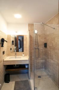a bathroom with a sink and a shower at Aticos La Riba in Luanco +29 photos