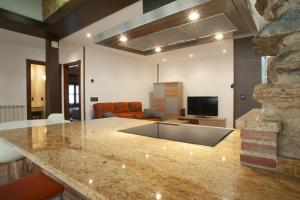 a kitchen and living room with a counter and a living room at Aticos La Riba in Luanco