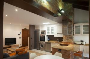 a living room with a kitchen and a living room at Aticos La Riba in Luanco