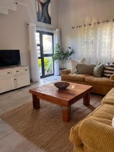 a living room with a couch and a coffee table at Loft on Honey in Sunridge Park