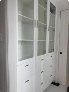 a white closet with glass shelves and cabinets at Modern Suite Near Adelaide CBD in Woodville