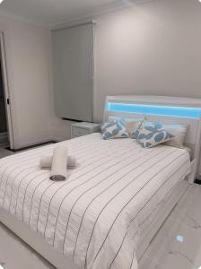 a bedroom with a white bed with pillows at Modern Suite Near Adelaide CBD in Woodville