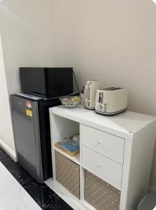 a microwave sitting on top of a table with a toaster at Modern Suite Near Adelaide CBD in Woodville