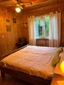 a bedroom with a large bed in a cabin at Chata filozofa pod Policą in Skawica