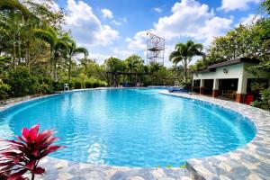 a large swimming pool with blue water at Kamayan sa Palaisdaan Hotel and Resort Quezon in Lucban