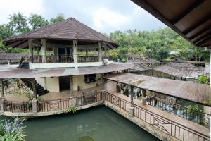 an image of a house with a pool of water at Kamayan sa Palaisdaan Hotel and Resort Quezon in Lucban