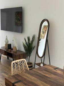 a living room with a mirror and a table at GUACAMAYOS in Cádiz +58 photos