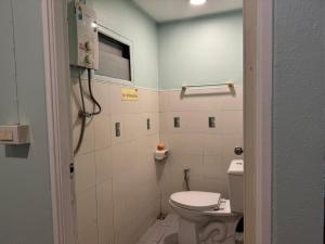 a bathroom with a toilet and a window at Baan Kao Kod in Nakhon Si Thammarat +16 photos