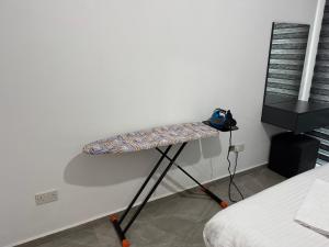 a shelf in the corner of a room next to a bed at Veray Homes, Alsancak in Ayios Dhometios